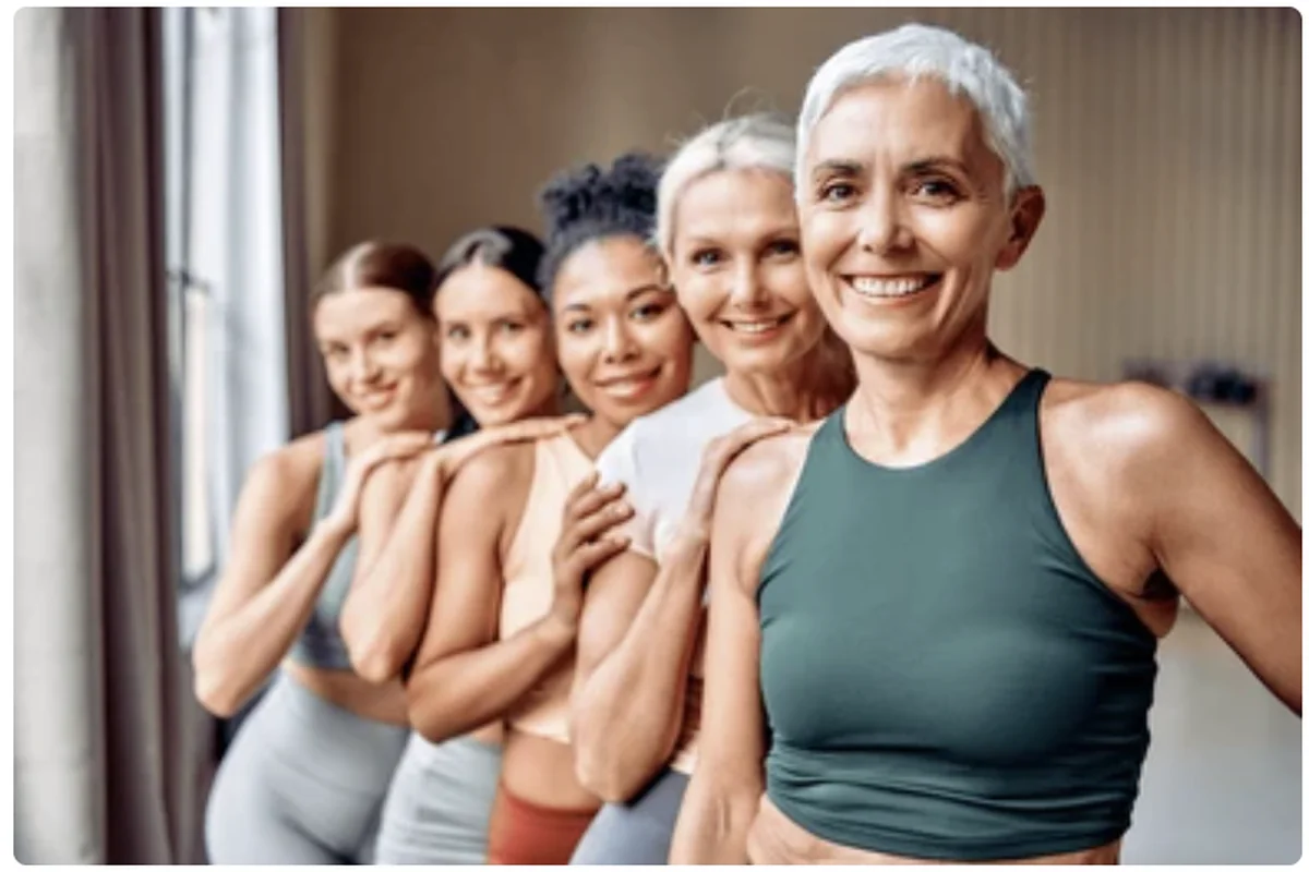 Diverse group of confident women of different ages smiling together in activewear